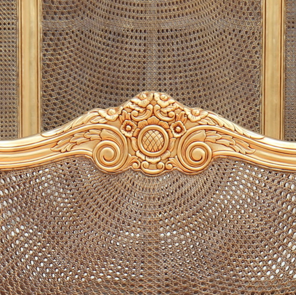 close up of footboard of french rattan bed