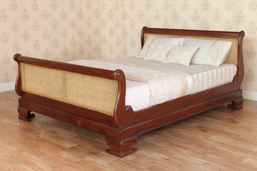 Rattan French sleigh bed featuring rattan headboard and footboard